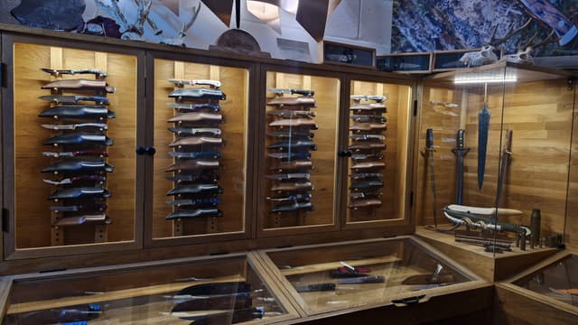 The showroom, its glass cabinets lined with finished knives
