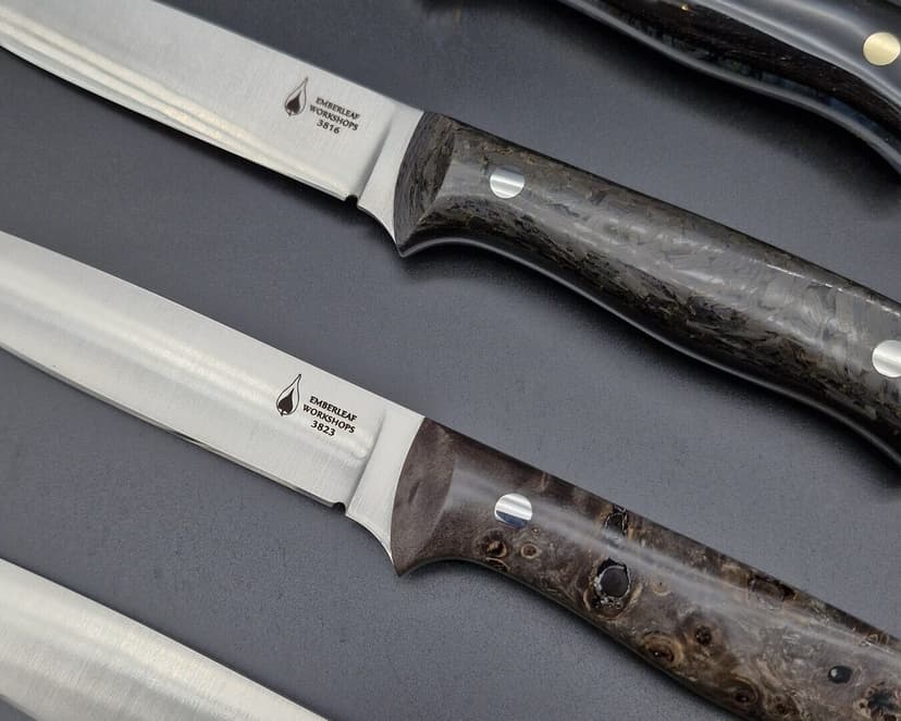 Satin-finished blades laid side by side, each stamped with its project number