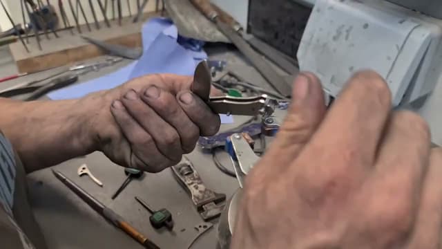 Hands assembling a folding knife at the bench