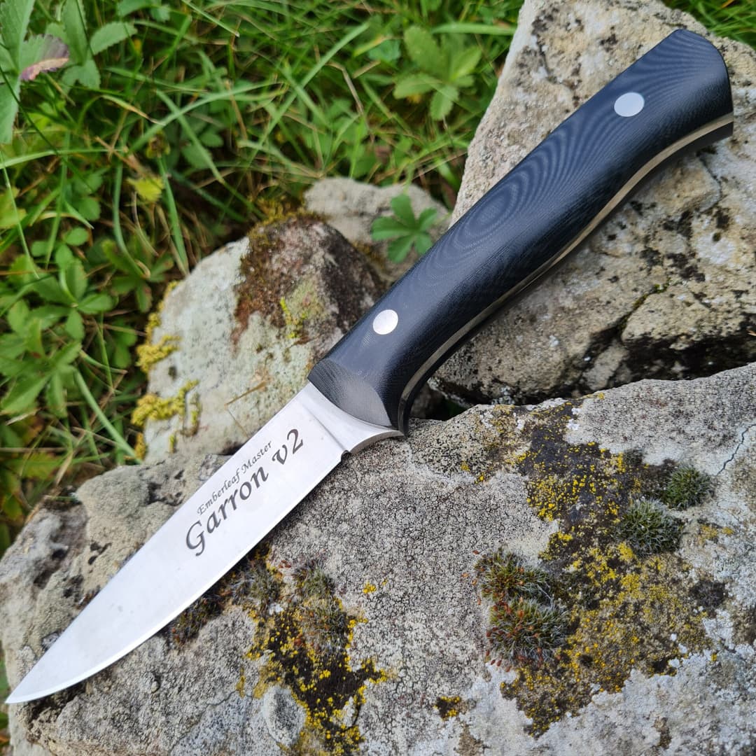 The Garron v2 master, its blade engraved Emberleaf Master